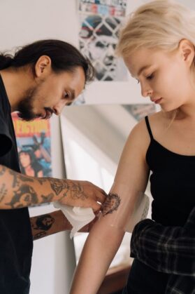 Pexels - free to use
https://www.pexels.com/photo/a-tattoo-artist-wrapping-a-new-tattoo-5088508/